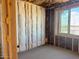 Unfinished bedroom features a window and wood framing with insulation at 5633 W Mcneil St, Laveen, AZ 85339