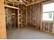 An in-progress bedroom features insulation, framing for a closet, and a window offering natural light at 5633 W Mcneil St, Laveen, AZ 85339