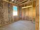 An in-progress bedroom features insulation, framing for a closet, and a window offering natural light at 5633 W Mcneil St, Laveen, AZ 85339