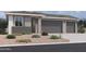 Charming single-story home featuring a two-car garage and desert landscaping at 5633 W Mcneil St, Laveen, AZ 85339