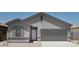Charming single-Gathering home featuring a two-car garage and neutral-toned stucco exterior at 5839 W Willow Ridge Dr, Laveen, AZ 85339