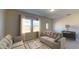 Comfortable living room featuring neutral tones, plush seating, bright natural light, and stylish decor at 5839 W Willow Ridge Dr, Laveen, AZ 85339