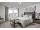Serene main bedroom with a tufted headboard, natural light, and tasteful decor at 5839 W Willow Ridge Dr, Laveen, AZ 85339