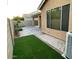Inviting backyard with artificial turf, brick-lined walkways, and desert landscaping at 61 W Hackberry Dr, Chandler, AZ 85248