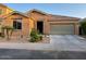 Charming single-story home featuring stone accents, desert landscaping, and an attached two-car garage at 61 W Hackberry Dr, Chandler, AZ 85248