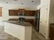 Kitchen featuring granite counters, stainless appliances, and central island with sink at 61 W Hackberry Dr, Chandler, AZ 85248