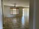Living room featuring tiled flooring, ceiling fan, and window with wood blinds at 61 W Hackberry Dr, Chandler, AZ 85248