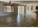 Open living room with tile flooring, ceiling fan, wood blinds, and backyard access at 61 W Hackberry Dr, Chandler, AZ 85248