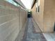 Narrow side yard with a walkway and tall block wall at 61 W Hackberry Dr, Chandler, AZ 85248
