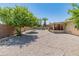 Wide backyard with desert landscaping, mature trees, and a partially covered patio at 6217 E El Paso St, Mesa, AZ 85205