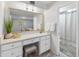 Bright bathroom featuring a vanity area, a large mirror, and neutral finishes at 6217 E El Paso St, Mesa, AZ 85205