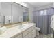 Traditional bathroom with a vanity, a large mirror, and neutral finishes at 6217 E El Paso St, Mesa, AZ 85205