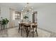 Bright dining room with a wooden table, stylish light fixture, and a view to the outdoors at 6217 E El Paso St, Mesa, AZ 85205