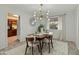 Cozy dining room featuring modern lighting, a wooden table, and neutral tones at 6217 E El Paso St, Mesa, AZ 85205