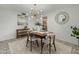 Dining area with stylish light fixture, seating for four, and an open view into the living room at 6217 E El Paso St, Mesa, AZ 85205