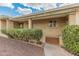 Close-up of a brick single-story home with covered entrance and landscaped with mature bushes at 6217 E El Paso St, Mesa, AZ 85205