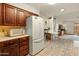 Bright kitchen featuring wood cabinets, white appliances, and an open layout at 6217 E El Paso St, Mesa, AZ 85205