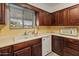Functional kitchen with classic wood cabinetry, white appliances, and ample countertop space at 6217 E El Paso St, Mesa, AZ 85205