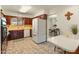 Kitchen with white appliances and warm wood cabinetry, adjacent to the dining area at 6217 E El Paso St, Mesa, AZ 85205