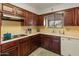Classic kitchen featuring wood cabinets, white countertops, and stainless steel appliances at 6217 E El Paso St, Mesa, AZ 85205