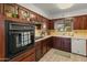 Well-maintained kitchen with dark wood cabinets and updated appliances at 6217 E El Paso St, Mesa, AZ 85205