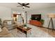 Bright living room featuring a ceiling fan, tile floor, and a view to the kitchen at 6217 E El Paso St, Mesa, AZ 85205