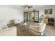 Spacious living room with neutral tones, plush carpet, and views into the dining area at 6217 E El Paso St, Mesa, AZ 85205