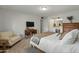 Inviting main bedroom with an ensuite, carpet floor, and a side chair at 6217 E El Paso St, Mesa, AZ 85205