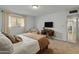 Comfortable main bedroom with a TV, carpet floor, and natural light at 6217 E El Paso St, Mesa, AZ 85205