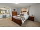 Cozy main bedroom showcasing a bath, wooden furniture, and carpet at 6217 E El Paso St, Mesa, AZ 85205