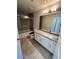 Bathroom with a shower-tub combo, gray tile surround, and a vanity at 7009 E Acoma Dr # 1101, Scottsdale, AZ 85254