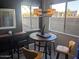 Dining area featuring a stylish table, chairs, modern lighting, and natural light from large windows at 7009 E Acoma Dr # 1101, Scottsdale, AZ 85254