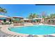 Community pool featuring lounge chairs, umbrellas, and lush landscaping at 7009 E Acoma Dr # 1101, Scottsdale, AZ 85254