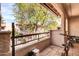 Outdoor balcony with Spanish tile and views of a lush, green landscape at 9396 E Purdue Ave # 220, Scottsdale, AZ 85258