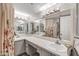 Bright bathroom featuring double sinks, quartz countertops and custom cabinets at 9396 E Purdue Ave # 220, Scottsdale, AZ 85258