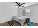 Bedroom features a queen-sized bed, wood-look floors, ceiling fan, and natural light at 9396 E Purdue Ave # 220, Scottsdale, AZ 85258