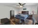 Comfortable bedroom features a ceiling fan, dark wood furniture, and warm neutral tones at 9396 E Purdue Ave # 220, Scottsdale, AZ 85258