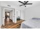 Bedroom features wood-look floors, closet with mirrored doors, and attached living area at 9396 E Purdue Ave # 220, Scottsdale, AZ 85258