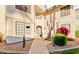 Exterior of building shows staircase leading to front door and flowering shrubbery at 9396 E Purdue Ave # 220, Scottsdale, AZ 85258