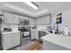 A modern kitchen featuring stainless steel appliances, white countertops, and dark wood floors at 9396 E Purdue Ave # 220, Scottsdale, AZ 85258