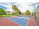 An exterior view of the community's well-maintained pickleball courts with trees and condos in the background at 9396 E Purdue Ave # 220, Scottsdale, AZ 85258