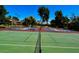 Exterior shot looking through the tennis net at the community tennis courts with landscaping and trees at 9396 E Purdue Ave # 220, Scottsdale, AZ 85258