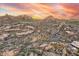 Desert houses blend with a landscape with striking mountain under the beautiful sunset skies at 10671 E Hedgehog Pl, Scottsdale, AZ 85262