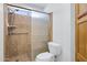 Bathroom featuring a tiled shower with glass door, toilet, and linen cabinet at 1120 N Val Vista Dr # 2, Gilbert, AZ 85234