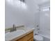 Clean bathroom with a wooden vanity, a large mirror, and a tub shower with white tile at 1120 N Val Vista Dr # 2, Gilbert, AZ 85234