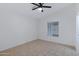Bright bedroom features neutral tile flooring, a ceiling fan, and natural light from the window at 1120 N Val Vista Dr # 2, Gilbert, AZ 85234