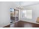 Dining area showcasing hardwood floors, modern chandelier, and sliding glass door to patio at 1120 N Val Vista Dr # 2, Gilbert, AZ 85234