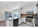 Modern kitchen equipped with stainless steel appliances, granite countertops, and an island with bar seating at 1120 N Val Vista Dr # 2, Gilbert, AZ 85234