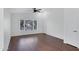 Inviting living room with wood floors, a ceiling fan, and a large window offering scenic outdoor views at 1120 N Val Vista Dr # 2, Gilbert, AZ 85234