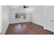 Bright and airy living room featuring wood floors, a ceiling fan, and a door leading to other rooms at 1120 N Val Vista Dr # 2, Gilbert, AZ 85234